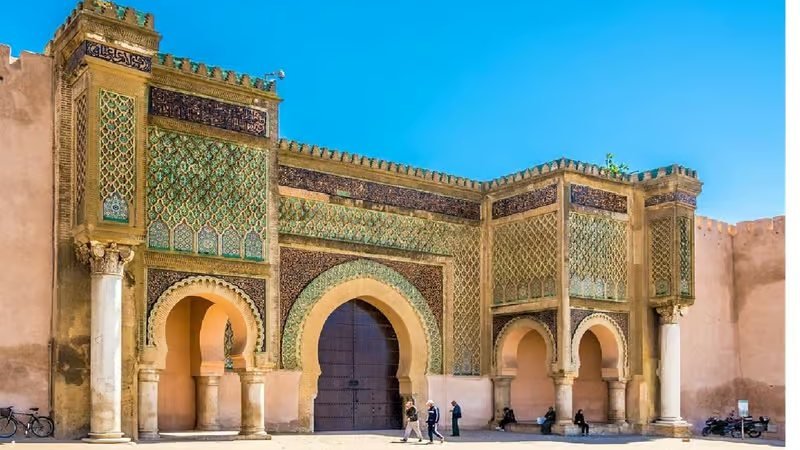 The tiled arches and green mosaic of Bab Mansour, the great gate of Meknes