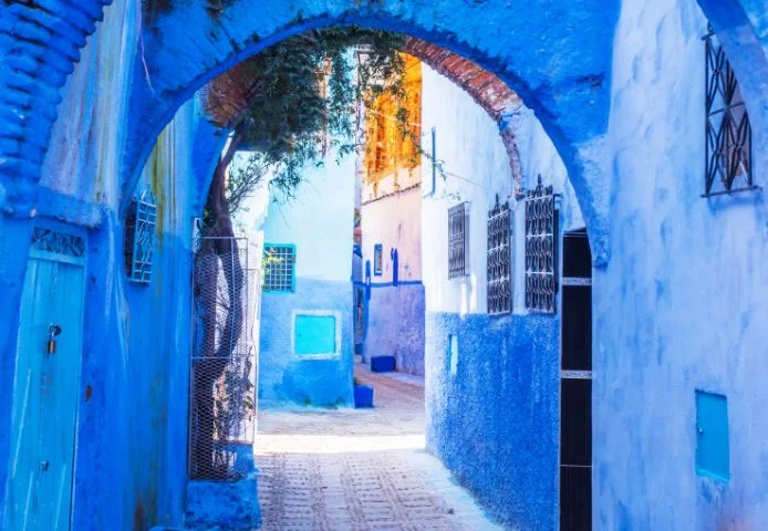 A blue-washed archway over a lane in the Chefchaouen medina