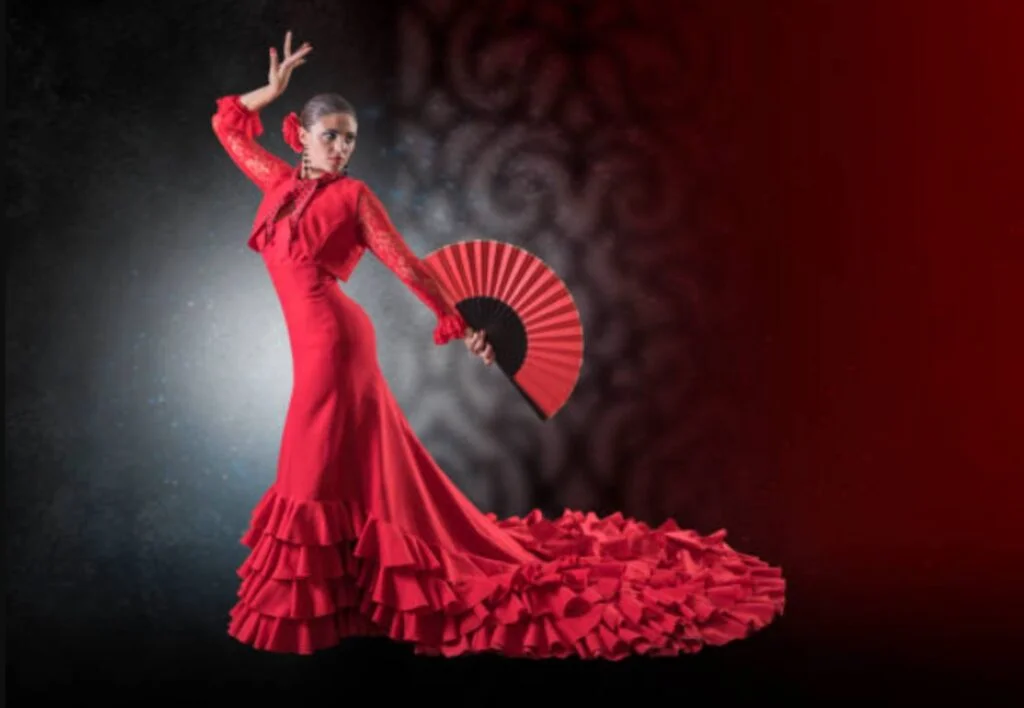 A flamenco dancer in a red ruffled dress holding a fan