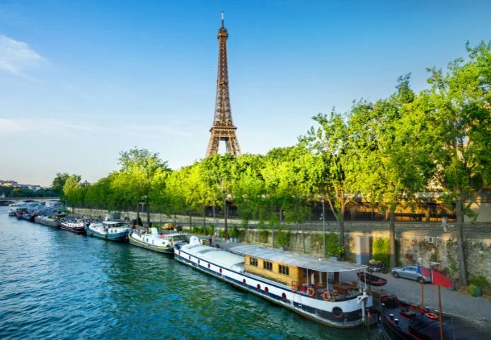Houseboats moored along the Seine with the Eiffel Tower behind